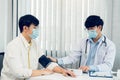 Doctor checking a senior patient blood pressure in office room Royalty Free Stock Photo