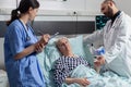 Doctor checking senior patient in hospital intensive care Royalty Free Stock Photo