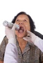 Doctor checking senior woman for sore throat Royalty Free Stock Photo