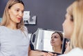 Doctor checking woman face skin in cosmetology clinic before plastic surgery