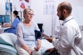 Doctor checking woman blood pressure