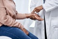 Doctor checking wrist pulse, heart rate and vitals of a sick patient during a healthcare consult, checkup and screening