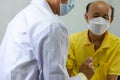 Doctor checks the heartbeat of an elderly man