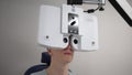 Doctor checks patient eyes using autoref keratometer. Laser vision correction.