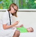 Doctor checks the temperature of baby