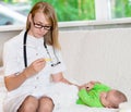 Doctor checks the temperature of baby