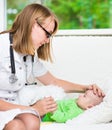 Doctor checks the temperature of baby touching his forehead Royalty Free Stock Photo