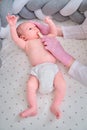 Doctor checks the throat of a newborn child with a plowshare. A nurse in uniform with a wooden stick in her hand examines the Royalty Free Stock Photo