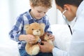 Doctor and child patient. Physician examines little boy by stethoscope. Medicine and children`s therapy concept Royalty Free Stock Photo