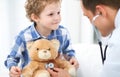 Doctor and child patient. Physician examines little boy by stethoscope. Medicine and children`s therapy concept Royalty Free Stock Photo