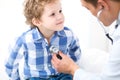 Doctor and child patient. Physician examines little boy by stethoscope. Medicine and children`s therapy concept