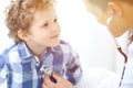 Doctor and child patient. Physician examines little boy by stethoscope. Medicine and children`s therapy concept