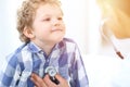 Doctor and child patient. Physician examines little boy by stethoscope. Medicine and children`s therapy concept Royalty Free Stock Photo