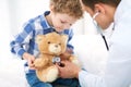 Doctor and child patient. Physician examines little boy by stethoscope. Medicine and children`s therapy concept Royalty Free Stock Photo