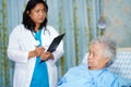 Doctor with clipboard for note diagnosis of patients in nursing hospital ward