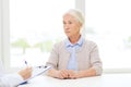 Doctor with clipboard and senior woman at hospital Royalty Free Stock Photo