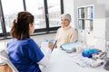 doctor with clipboard and senior woman at hospital Royalty Free Stock Photo