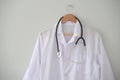 Doctor coat hanged on clinic office wall