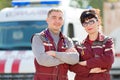 Doctor with colleague paramedic on ambulance vehicle background