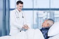 Doctor comforting his elderly patient in hospital Royalty Free Stock Photo