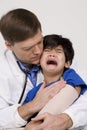 Doctor comforting a scared little boy Royalty Free Stock Photo