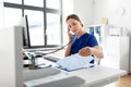 Doctor with computer calling on phone at hospital Royalty Free Stock Photo