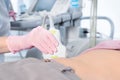 Doctor conducting ultrasound examination of patient`s abdomen in clinic Royalty Free Stock Photo