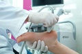 Doctor conducting ultrasound of patient`s foot in clinic, closeup