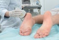 Doctor conducting ultrasound examination of patient`s foot