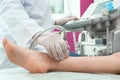 Doctor conducting ultrasound examination of patient`s leg in clinic Royalty Free Stock Photo