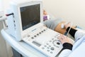 The doctor conducts an ultrasound of the stomach of a young girl. Close-up of equipment