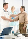 Doctor congratulating senior patient on recovery Royalty Free Stock Photo
