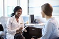 Doctor In Consultation With Female Patient In Office Royalty Free Stock Photo