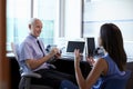 Doctor In Consultation With Female Patient In Office Royalty Free Stock Photo