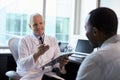 Doctor In Consultation With Male Patient In Office Royalty Free Stock Photo