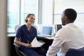 Doctor In Consultation With Male Patient In Office Royalty Free Stock Photo