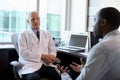 Doctor In Consultation With Male Patient In Office Royalty Free Stock Photo