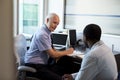 Doctor In Consultation With Male Patient In Office Royalty Free Stock Photo