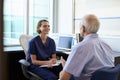 Doctor In Consultation With Male Patient In Office Royalty Free Stock Photo