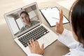 Doctor consulting indian woman patient by online video call on laptop screen.