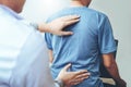 Doctor consulting with patient Back problems Physical therapy co Royalty Free Stock Photo