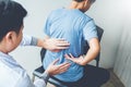 Doctor consulting with patient Back problems Physical therapy co Royalty Free Stock Photo