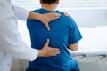Doctor consulting with patient Back problems Physical therapy concept Royalty Free Stock Photo