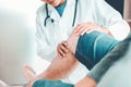 Doctor consulting with patient Knee problems Physical therapy co Royalty Free Stock Photo