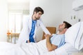 Doctor consulting patient lying on hospital bed talking worried giving bad news about the diagnose