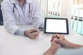 Doctor consulting patient and recommend treatment methods and how to rehabilitate the body, presenting results on tablet computer Royalty Free Stock Photo