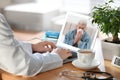 Doctor consulting sick patient online by video chat in medical office Royalty Free Stock Photo