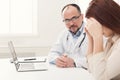 Doctor consulting woman in hospital