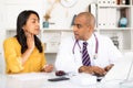 Doctor consulting woman patient complaining of sore throat