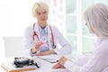Doctor consults mature woman about breast cancer risk